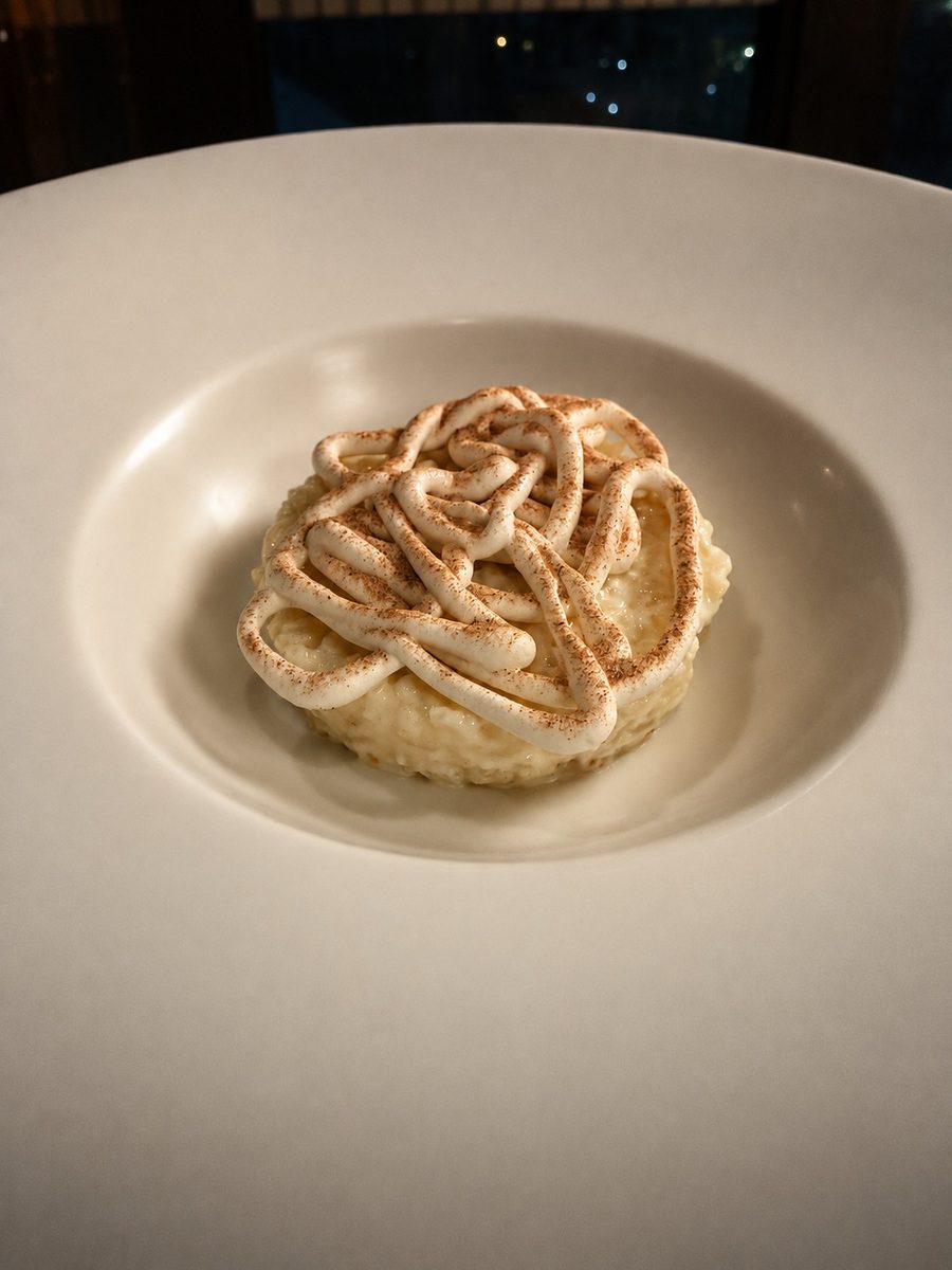 Plated dessert with piped cream lattice and a dusting of spice